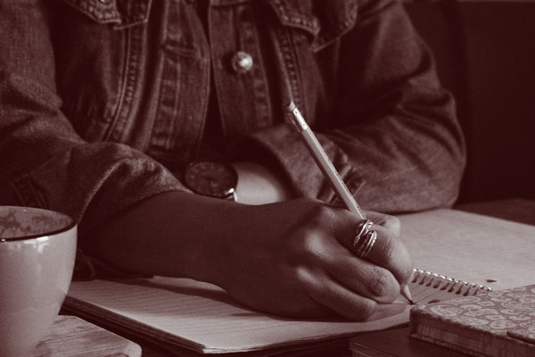 Woman writing on her notebook