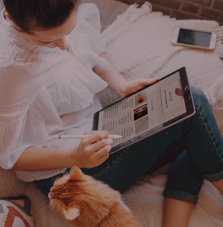 Woman reading Rachel Thompson articles on tablet