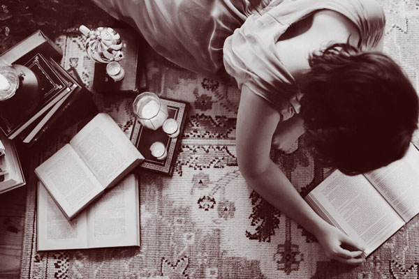 Writer reading books on the floor